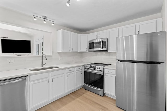 447 Old Connecticut Path, Framingham, MA 01701 - kitchen with appliances with stainless steel finishes, a sink, white cabinetry, and light wood finished floors