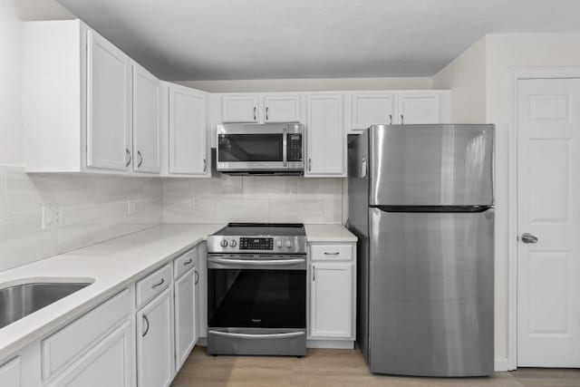 447 Old Connecticut Path, Framingham, MA 01701 - kitchen featuring appliances with stainless steel finishes, white cabinetry, and light countertops