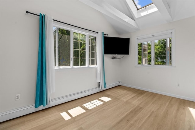 447 Old Connecticut Path, Framingham, MA 01701 - spare room featuring a skylight, vaulted ceiling, a baseboard heating unit, wood finished floors, and baseboards