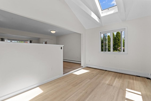 447 Old Connecticut Path, Framingham, MA 01701 - empty room with a baseboard radiator, a baseboard heating unit, a skylight, wood finished floors, and high vaulted ceiling