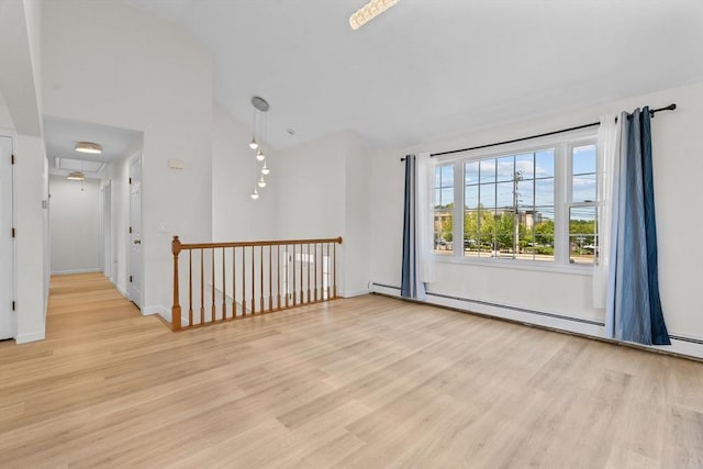447 Old Connecticut Path, Framingham, MA 01701 - spare room with vaulted ceiling, light wood-style flooring, a baseboard heating unit, and baseboards