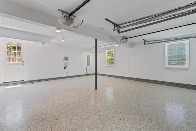 447 Old Connecticut Path, Framingham, MA 01701 - garage featuring electric panel, a garage door opener, and baseboards