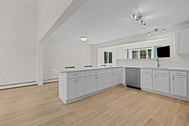 447 Old Connecticut Path, Framingham, MA 01701 - kitchen featuring stainless steel dishwasher, a sink, a peninsula, and light wood finished floors
