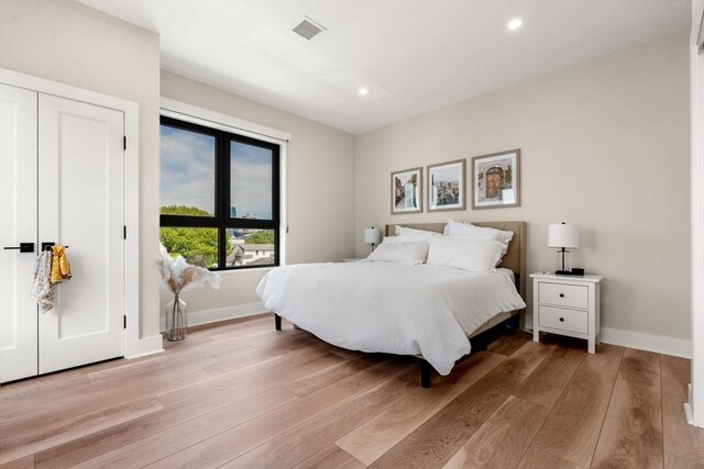 388 Athens St Unit 1, Boston, MA 02127 - bedroom with light wood finished floors, recessed lighting, and baseboards