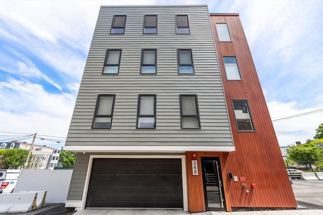 388 Athens St Unit 1, Boston, MA 02127 - view of front of house featuring an attached garage and driveway