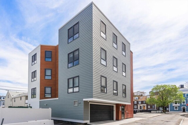 388 Athens St Unit 1, Boston, MA 02127 - view of building exterior featuring an attached garage