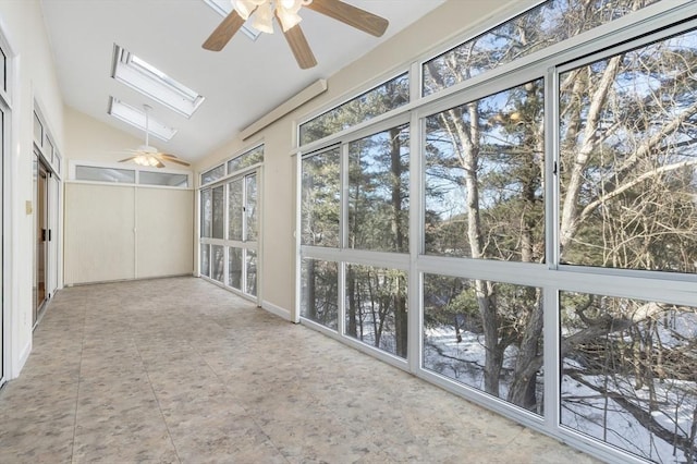 unfurnished sunroom with vaulted ceiling with skylight and a ceiling fan