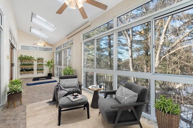 sunroom / solarium featuring vaulted ceiling with skylight and a ceiling fan