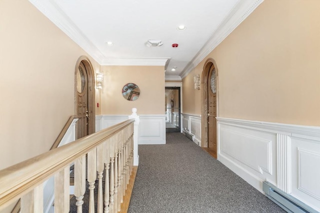 corridor with carpet floors, baseboard heating, an upstairs landing, and recessed lighting