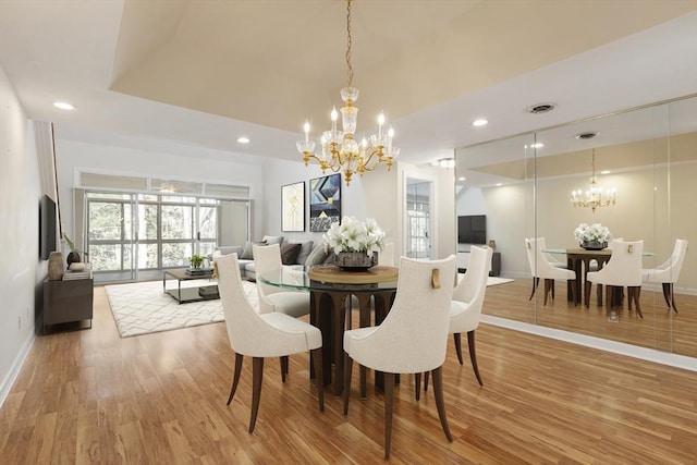 dining room with an inviting chandelier, light wood-style flooring, visible vents, and recessed lighting