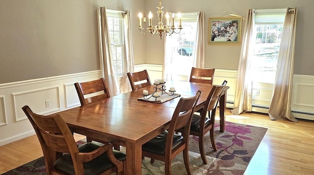 7 Hemlock, Kingston, MA 02364 - dining area featuring a decorative wall, a notable chandelier, wainscoting, and a healthy amount of sunlight