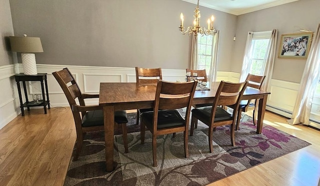 7 Hemlock, Kingston, MA 02364 - dining space with a chandelier, ornamental molding, a wainscoted wall, and wood finished floors