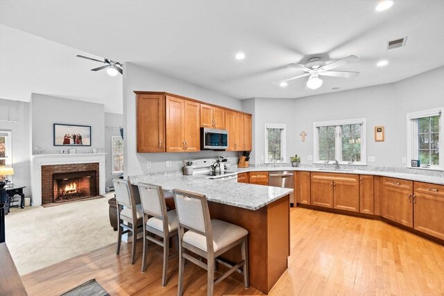 7 Hemlock, Kingston, MA 02364 - kitchen with visible vents, appliances with stainless steel finishes, a peninsula, and a ceiling fan