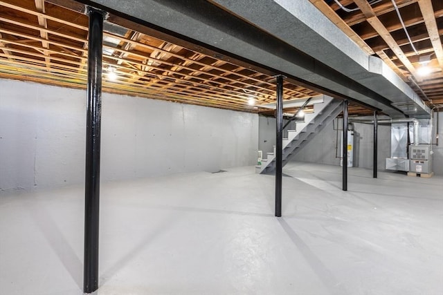 basement featuring heating unit and water heater