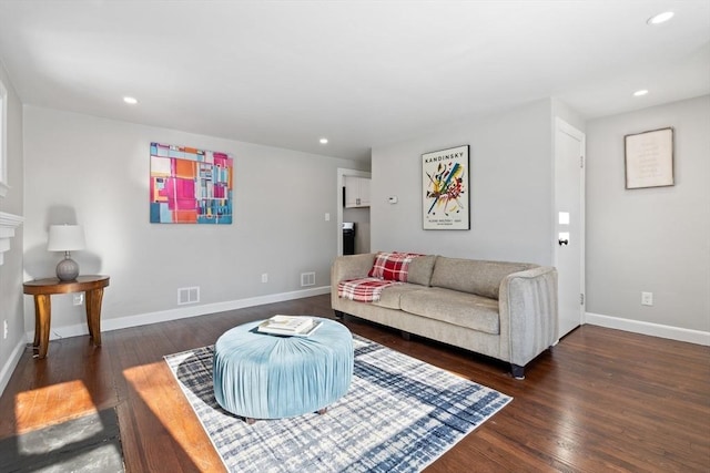 living room with dark hardwood / wood-style flooring