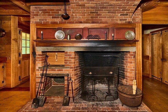 room details with wood-type flooring and a brick fireplace