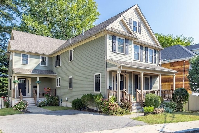 view of front of home with a shingled roof and covered porch