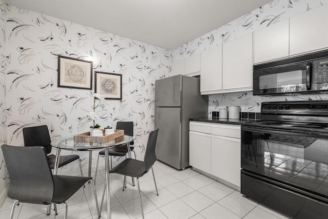 210 Nahanton St Unit 504, Newton, MA 02459 - kitchen featuring black appliances, wallpapered walls, white cabinets, dark countertops, and light tile patterned floors
