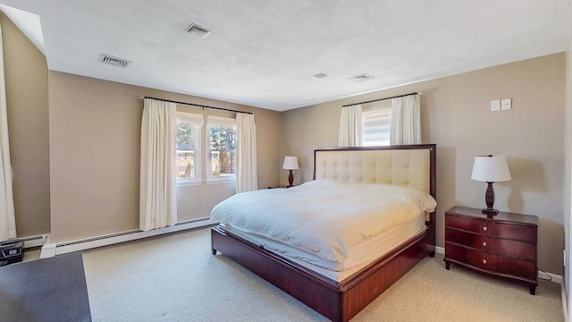 carpeted bedroom with a baseboard radiator and visible vents