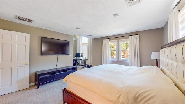 bedroom with carpet floors, baseboards, and visible vents