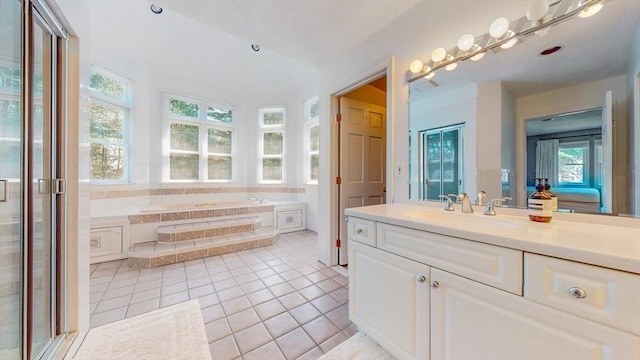 full bath featuring tile patterned flooring, a bath, and vanity