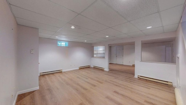 below grade area featuring wood finished floors and a baseboard radiator