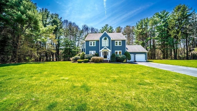 colonial house featuring driveway and a front lawn