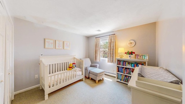carpeted bedroom with a nursery area, baseboards, baseboard heating, and visible vents