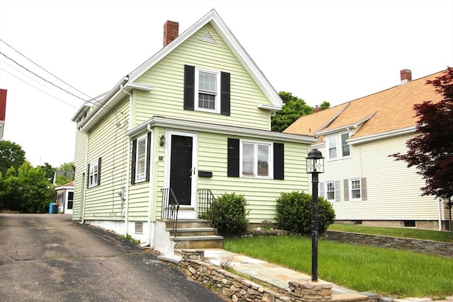 75 Wachusett St, Franklin, MA 02038 - view of front of home featuring entry steps and a chimney