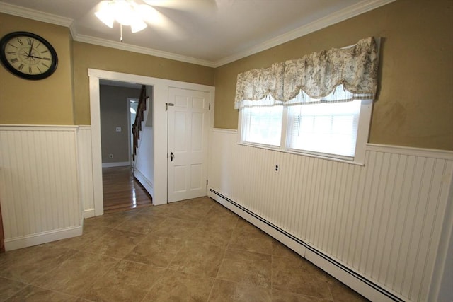 75 Wachusett St, Franklin, MA 02038 - tiled empty room featuring a baseboard heating unit, a wainscoted wall, crown molding, and ceiling fan
