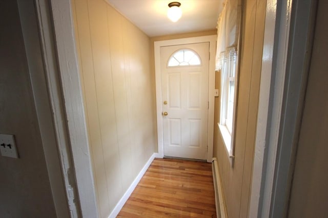 75 Wachusett St, Franklin, MA 02038 - doorway with light wood-style flooring, baseboard heating, and baseboards