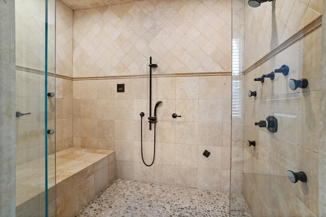 bathroom with a tile shower