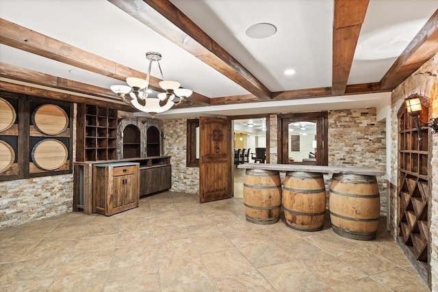 wine area with beam ceiling and an inviting chandelier