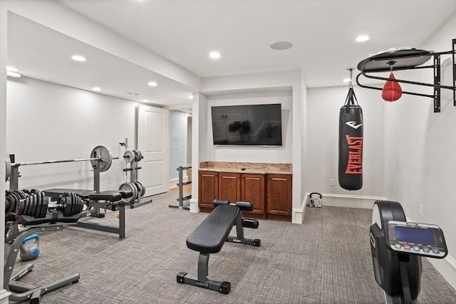 exercise area featuring recessed lighting, light colored carpet, and baseboards