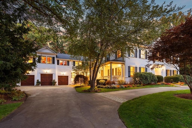 view of front of property with driveway, a front lawn, and a garage