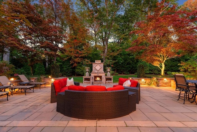 view of patio featuring an outdoor living space with a fireplace