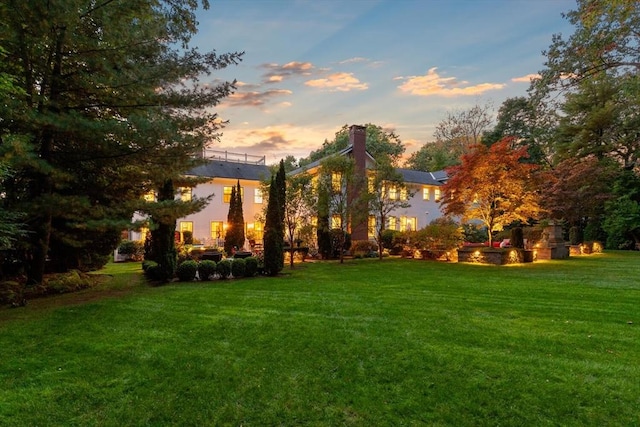 exterior space with a lawn and a chimney