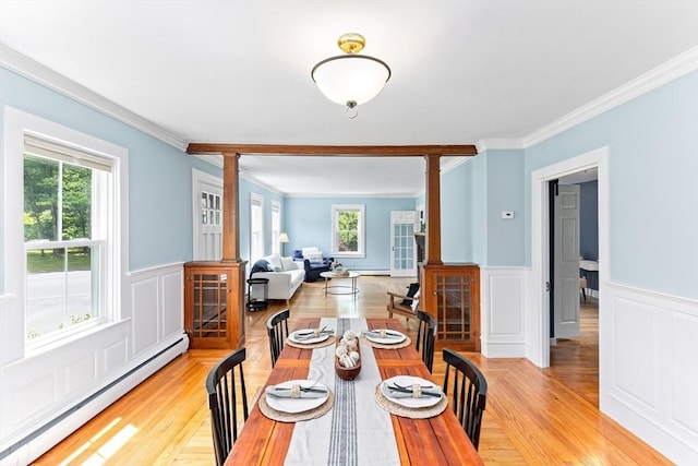 100 Gilbert St, Mansfield, MA 02048 - dining room featuring a baseboard heating unit, ornate columns, crown molding, healthy amount of natural light, and wainscoting