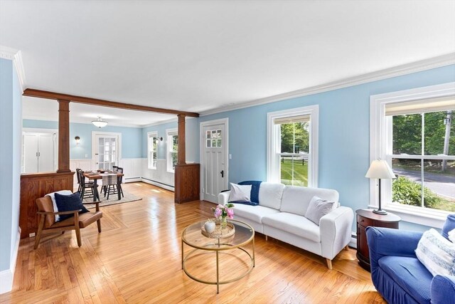 100 Gilbert St, Mansfield, MA 02048 - living room featuring ornate columns, ornamental molding, a wainscoted wall, baseboard heating, and light wood-type flooring