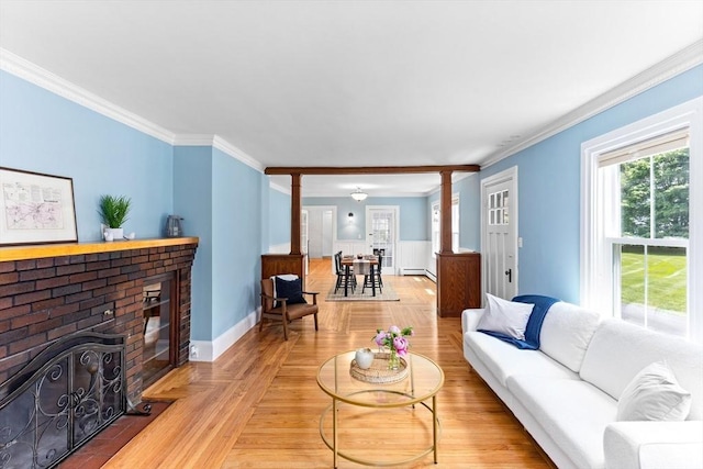 100 Gilbert St, Mansfield, MA 02048 - living room with ornamental molding, ornate columns, a brick fireplace, baseboards, and a baseboard radiator