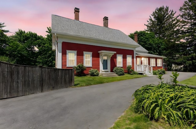 100 Gilbert St, Mansfield, MA 02048 - view of front facade with a chimney and driveway