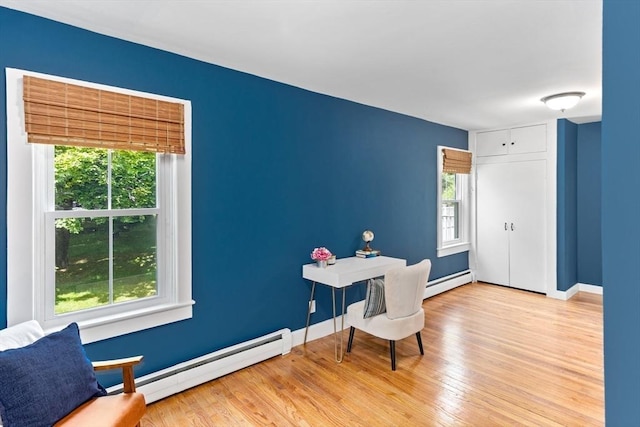 100 Gilbert St, Mansfield, MA 02048 - living area featuring a baseboard heating unit, light wood finished floors, and baseboards