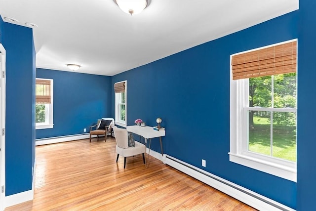 100 Gilbert St, Mansfield, MA 02048 - home office with a baseboard heating unit, plenty of natural light, and wood finished floors