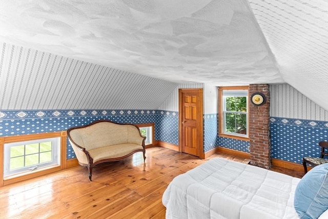 100 Gilbert St, Mansfield, MA 02048 - bedroom featuring wallpapered walls, hardwood / wood-style floors, lofted ceiling, and baseboards