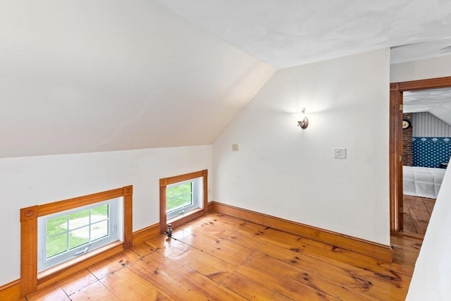 100 Gilbert St, Mansfield, MA 02048 - additional living space with vaulted ceiling, light wood-type flooring, and baseboards