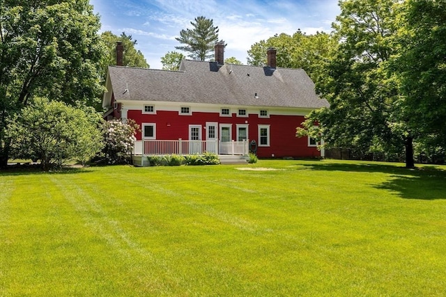 100 Gilbert St, Mansfield, MA 02048 - back of house with a lawn, a deck, and a chimney