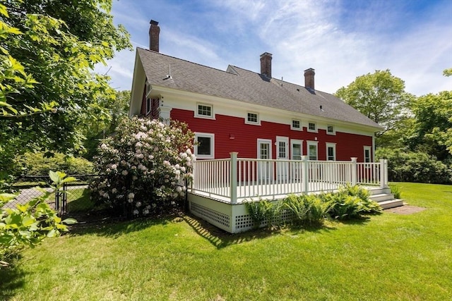 100 Gilbert St, Mansfield, MA 02048 - rear view of house with a wooden deck and a chimney
