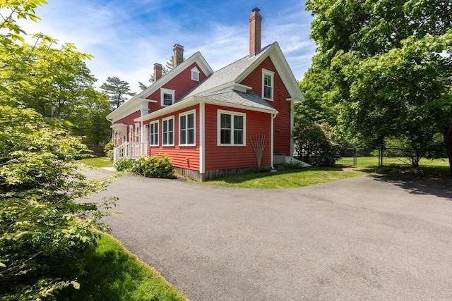 100 Gilbert St, Mansfield, MA 02048 - view of side of home with a chimney and driveway