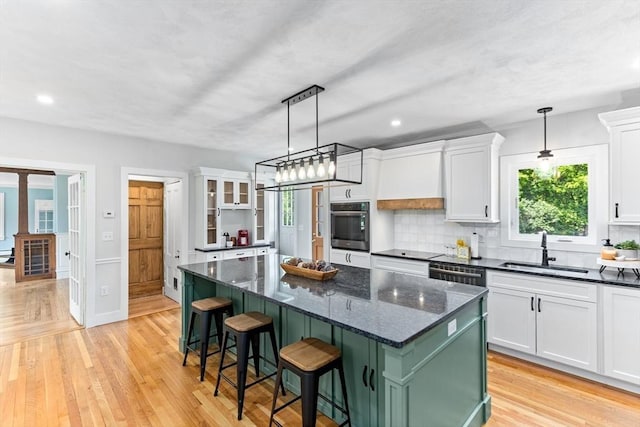 100 Gilbert St, Mansfield, MA 02048 - kitchen featuring a sink, stainless steel appliances, white cabinets, a kitchen island, and recessed lighting