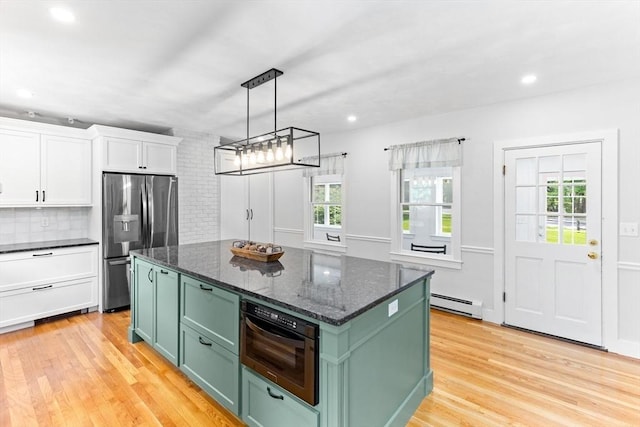 100 Gilbert St, Mansfield, MA 02048 - kitchen featuring green cabinets, stainless steel fridge with ice dispenser, oven, baseboard heating, and white cabinetry